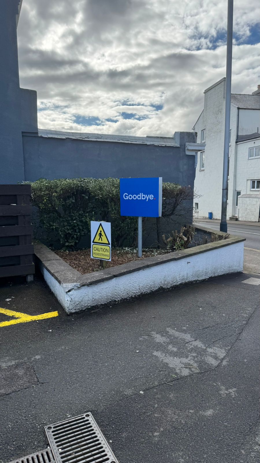 Street-level planter and surrounding hardstanding kept neat